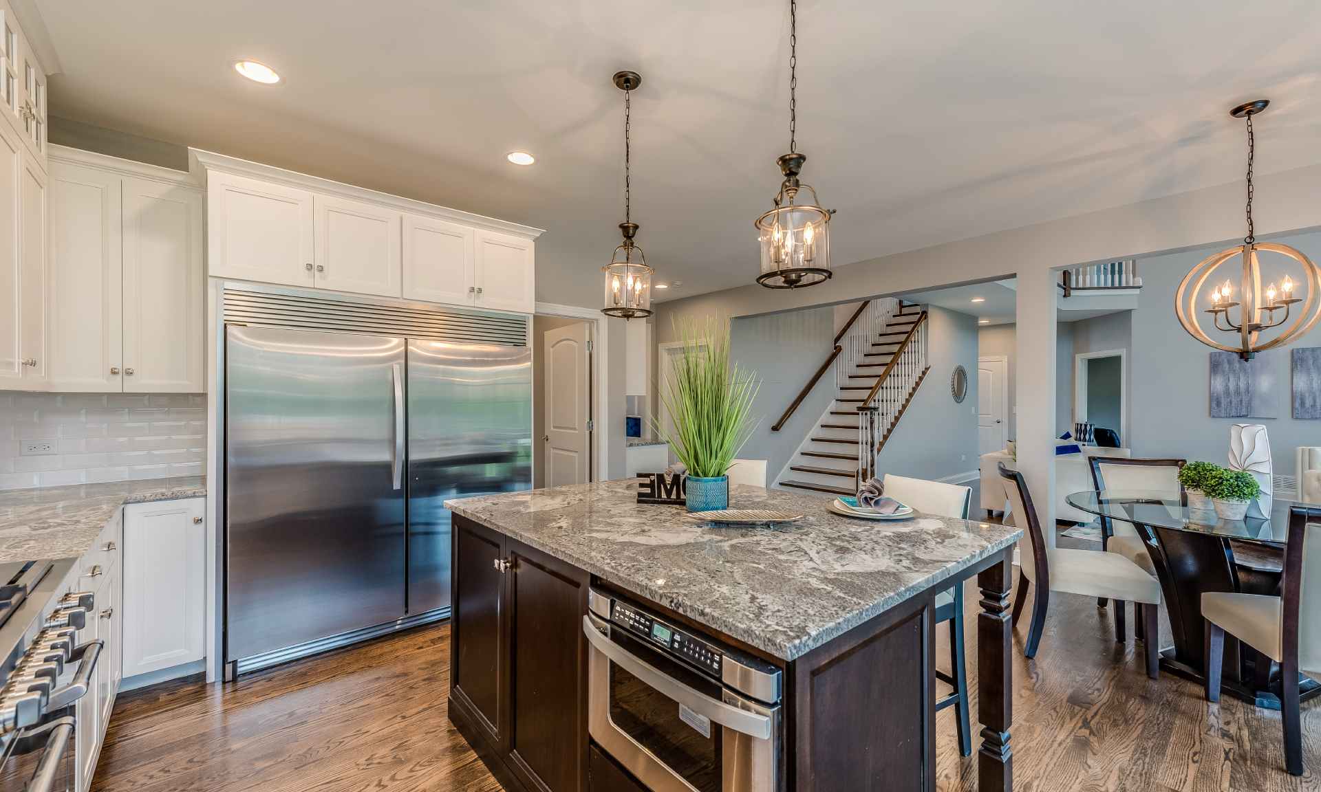 A kitchen with a large island and stainless steel appliances.